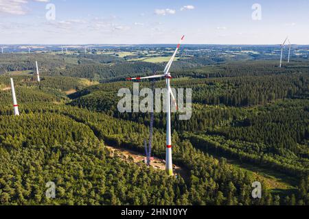Aerial view of wind farm construction site featuring a tall turbine ...