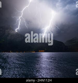 Mountain landscape by storm and rain. Discharge of lightning strikes the top of the mountains. Stock Photo