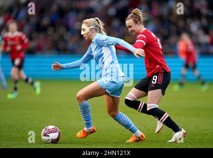 Manchester City's Alex Greenwood (left) and Manchester United's Martha Thomas battle for the ball during the Barclays FA Women's Super League match at the Academy Stadium, Manchester. Picture date: Sunday February 13, 2022. Stock Photo