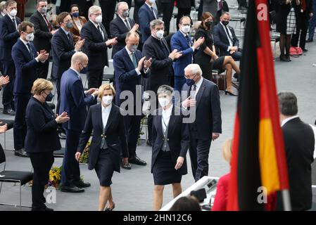 Berlin, Germany. 13th Feb, 2022. German President Frank-Walter Steinmeier (bottom right) places his hand on his chest after the announcement of the results of the election of the Federal President by the Federal Assembly in the Paul Löbe House, while politicians and celebrities applaud him. Former German Chancellor Angela Merkel (CDU) stands at the bottom left. Credit: Wolfgang Kumm/dpa-Zentralbild/dpa/Alamy Live News Stock Photo