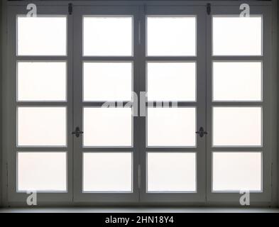 Window white color wooden frame background. Retro closed window with blur glass pane, old fashioned handle and white sill Stock Photo