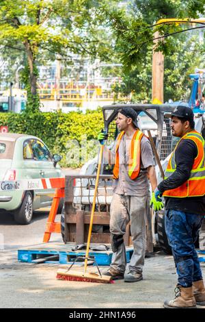 two road workers in hi vis rest during construction work in Vancouver canada Stock Photo