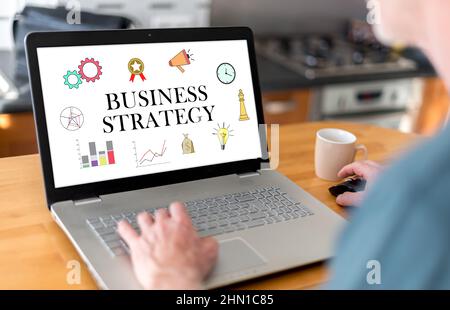 Man using a laptop with business strategy concept on the screen Stock Photo