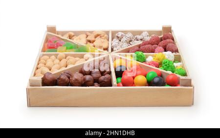 Set of nuts in a wooden box isolated on white. Stock Photo