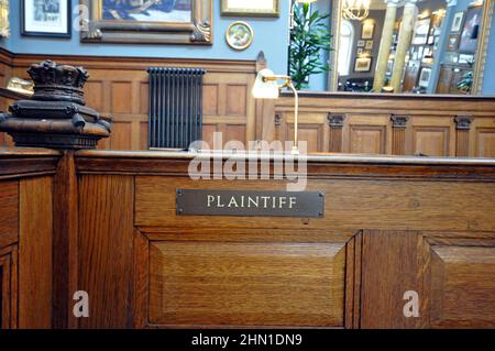 Plaintiff's seat within a court room, no people, traditional wooden courtroom Stock Photo