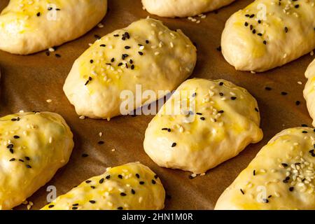 The dough is laid before baking on a baking sheet in the oven Stock Photo