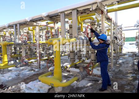 Sofia, Bulgaria - Jan 22 2022: A worker turning a valve in a gas compression station near Sofia Stock Photo