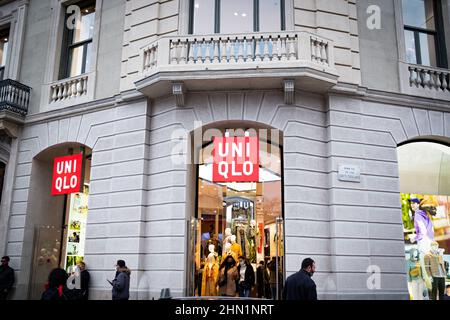 Spain. 12th Feb, 2022. People passes by a Uniqlo clothing and apparel store in the city downtown in Barcelona, Spain on February 12, 2022. (Photo by Davide Bonaldo/Sipa USA) Credit: Sipa USA/Alamy Live News Stock Photo