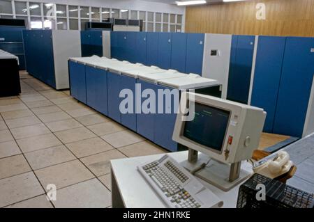 A mid-1980s view inside the Port Talbot Steelworks, an integrated steel production plant in Port Talbot, West Glamorgan, Wales, UK. This is a view of the company’s computer room. Massive mainframe computers were starting to play a big role in industry at this time. An IBM screen and keyboard are in the foreground. Laptops and tablets now have the computing power and speed to take over from the sizeable, defunct early machines. This image is from a vintage colour transparency – a vintage 1980s photograph. Stock Photo