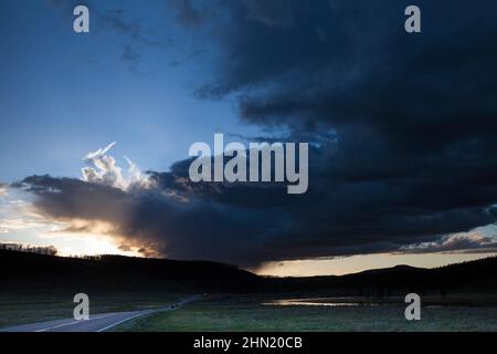 Thunderstorm receding at sunset beside Alum Creek in Hayden Valley, Yellowstone NP, Wyoming, USA Stock Photo