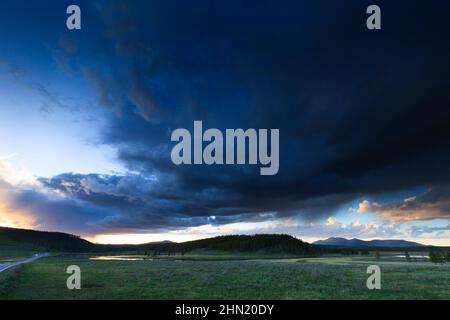 Thunderstorm receding at sunset beside Alum Creek in Hayden Valley, Yellowstone NP, Wyoming, USA Stock Photo