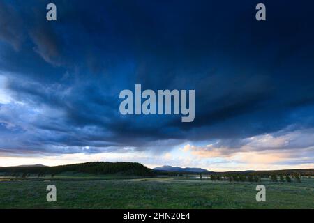 Thunderstorm receding at sunset beside Alum Creek in Hayden Valley, Yellowstone NP, Wyoming, USA Stock Photo