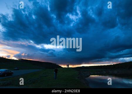 Thunderstorm receding at sunset beside Alum Creek in Hayden Valley, Yellowstone NP, Wyoming, USA Stock Photo