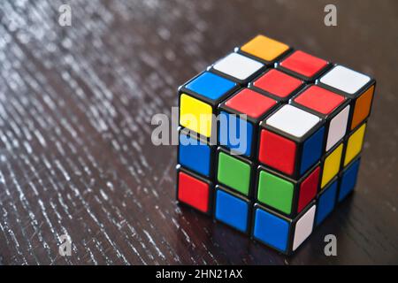 Colorful Rubik's cube on a wooden table Stock Photo