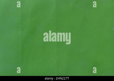 Green grunge background with folds. Old dusted packing paper surface Stock Photo