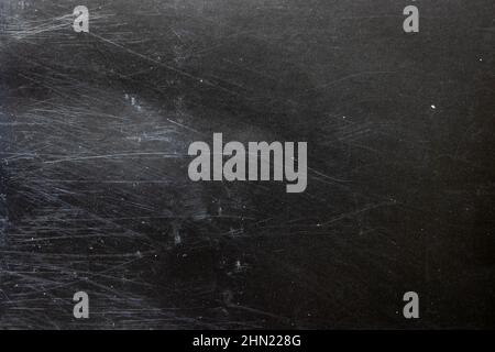 Dark grunge black paper background with scratches and dust. Stock Photo