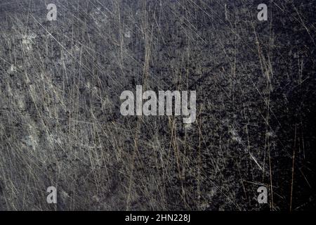 Dark grunge black old plastic cutting board background with scratches and dust. Stock Photo