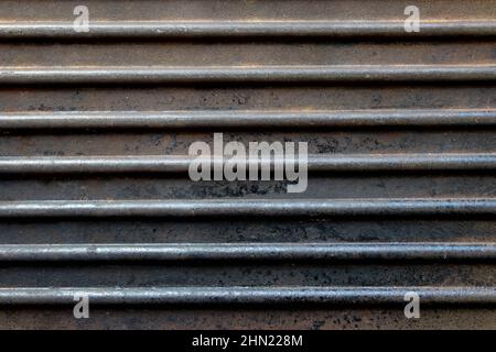 Dark horizontal ribbed rusted grunge background. Old cast iron pan grill surface Stock Photo