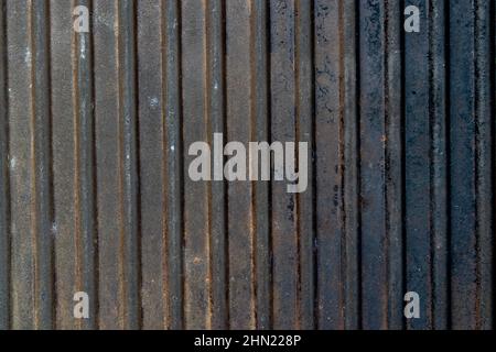 Dark vertical ribbed rusted grunge background. Old cast iron pan grill surface Stock Photo