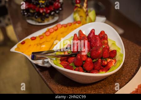 Catering sweets. Set with fresh strawberries and other fruits. Stock Photo