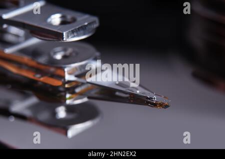 Open hard disk drive with magnetic head closeup. Stock Photo