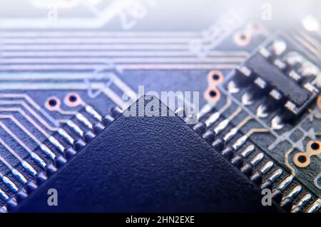 Macro photo of application specific integradet circuit in QFP package mounted on printed circuit board Stock Photo