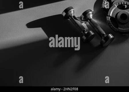 Close up of dumbbells on grey backgound. Sport and fitness equipment. Horizontal sport poster, greeting cards, headers, website. Stock Photo