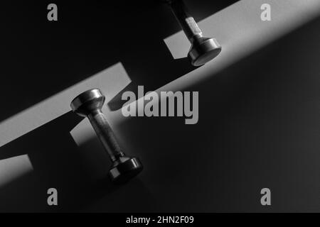 Close up of dumbbells on grey backgound. Sport and fitness equipment. Horizontal sport poster, greeting cards, headers, website. Stock Photo