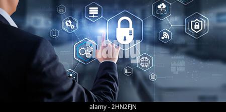 Businessman presses cybersecurity button on virtual screens. Stock Photo