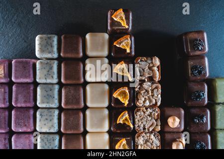 set of handmade chocolate candies with nuts, raisin, peanuts and hazelnut Stock Photo