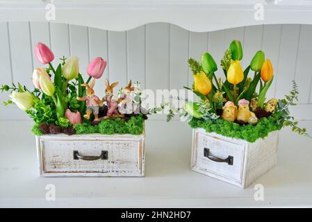 Tulip Artificial flower arrangements and rabbits on white furniture Stock Photo