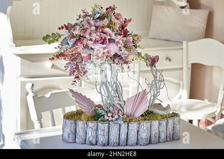 Artificial flower decoration on white furniture Stock Photo
