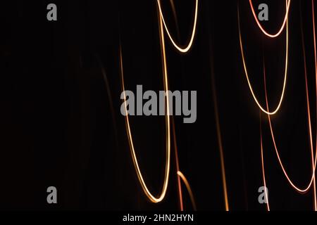 Abstract bright multi colored loops on a dark background. Digital back banner. Technology and science theme. Drawings with light. Stock Photo