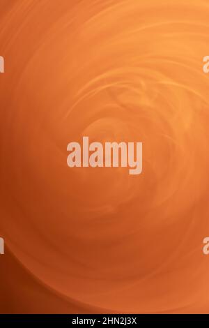 A whirlwind of orange sand. Vertical background abstraction. Backdrop Stock Photo