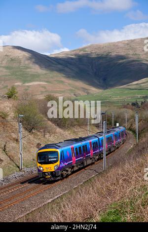 First Transpennine Express class 185 Diesel multiple unit 185139  in the Cumbrian countryside on the electrified west coast mainline Stock Photo