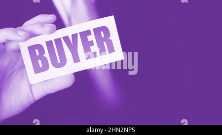 Buyer word on the card shown by a man. Customer business concept. Stock Photo