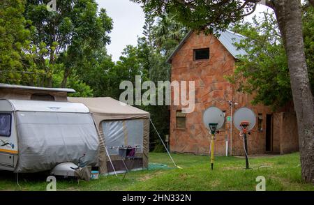 Two television dishes mounted on garden forks in a camping ground Stock Photo