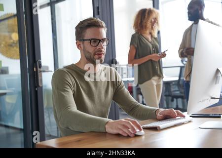 Serious man speaking with customer via internet Stock Photo
