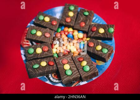 Chocolate car transport thematic cookies cakes with colorful candies as traffic lights for child baby boy birthday Stock Photo
