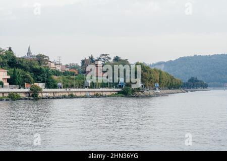 Milan, Italy - September 15, 2021: embankment at Como lake with beautiful landscape scenery at Lecco - travel destination in Lombardia Stock Photo