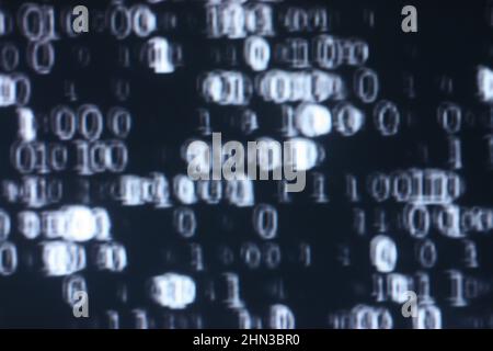 Illustration of running binary codes on a dark blurry background Stock Photo