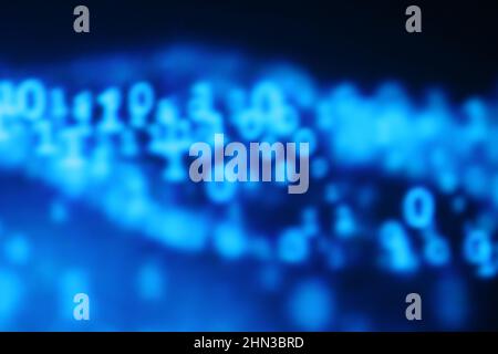 Illustration of running binary codes on a blue blurry background Stock Photo