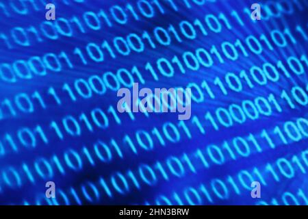 Illustration of running binary codes on a blue blurry background Stock Photo