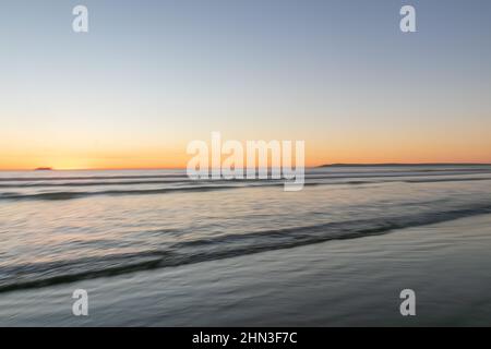 February 13, 2022: The clear sunset at Silver Strand State Beach in Coronado, California on Sunday, February 13th, 2022 (Rishi Deka/Zuma Press). The torrid weather allured many to the famous San Diego beach and nearby sites including Imperial Beach pier, Coronado Islands, Coronado Beach and Peninsula, downtown San Diego, San Diego Bay, cruise ships, and silver dollar shells. The heat wave in Southern California has now ended. (Credit Image: © Rishi Deka/ZUMA Press Wire) Stock Photo