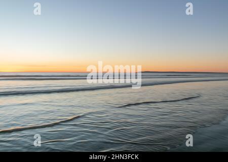 February 13, 2022: The clear sunset at Silver Strand State Beach in Coronado, California on Sunday, February 13th, 2022 (Rishi Deka/Zuma Press). The torrid weather allured many to the famous San Diego beach and nearby sites including Imperial Beach pier, Coronado Islands, Coronado Beach and Peninsula, downtown San Diego, San Diego Bay, cruise ships, and silver dollar shells. The heat wave in Southern California has now ended. (Credit Image: © Rishi Deka/ZUMA Press Wire) Stock Photo