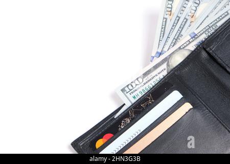 Black leather wallet with stack hundred dollar bills and bank cards on white background.Concept wealth and affluence Stock Photo