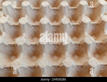 Protective cardboard packaging for storing eggs. Empty biodegradable molded egg box made of paper pulp. Stock Photo