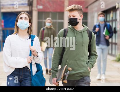 Two teenage students in protective masks Stock Photo