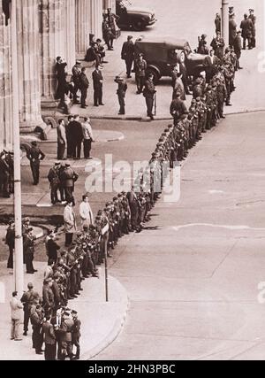 Vintage photo of Berlin Crisis of 1961: Building the Wall East German Infantrymen Line Up In Close Ranks to Seal Off Berlin's Key Border Crossing Poin Stock Photo