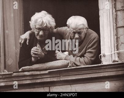 Vintage photo of Berlin Crisis of 1961: Building the Wall. Two Women on the Eastern Side of the Berlin Wall Show Their Emotions of Longing for Freedom Stock Photo